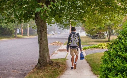 student walking on sidewalk
